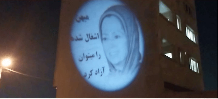 Iran-Shiraz: Projection of Image of Maryam Rajavi and the Slogan “The Occupied Homeland Can Be Freed.”